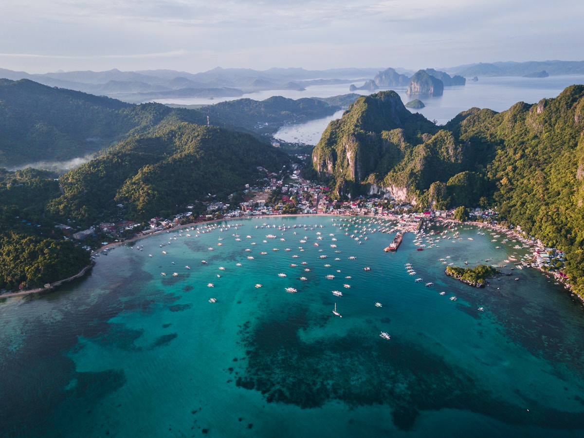 El Nido lagoon with traditional boats and limestone karst formations